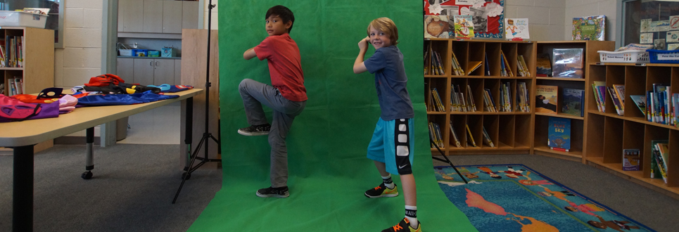 Two male students posing on the Green Screen